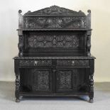 A continental carved oak sideboard