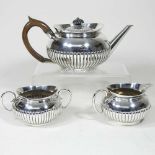 A silver three piece tea service