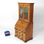 A George I style walnut apprentice bureau cabinet