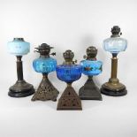 A collection of five oil lamp bases