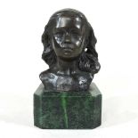 A bronze head of a girl