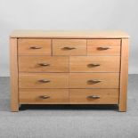 A modern light oak chest of drawers