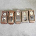 A collection of five wall clocks