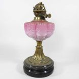 A 19th century pink glass oil lamp