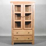 An oak glazed bookcase