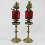 A pair of ruby glass peg oil lamps