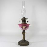 A brass and pink glass oil lamp base