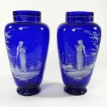 A pair of Mary Gregory style blue glass vases