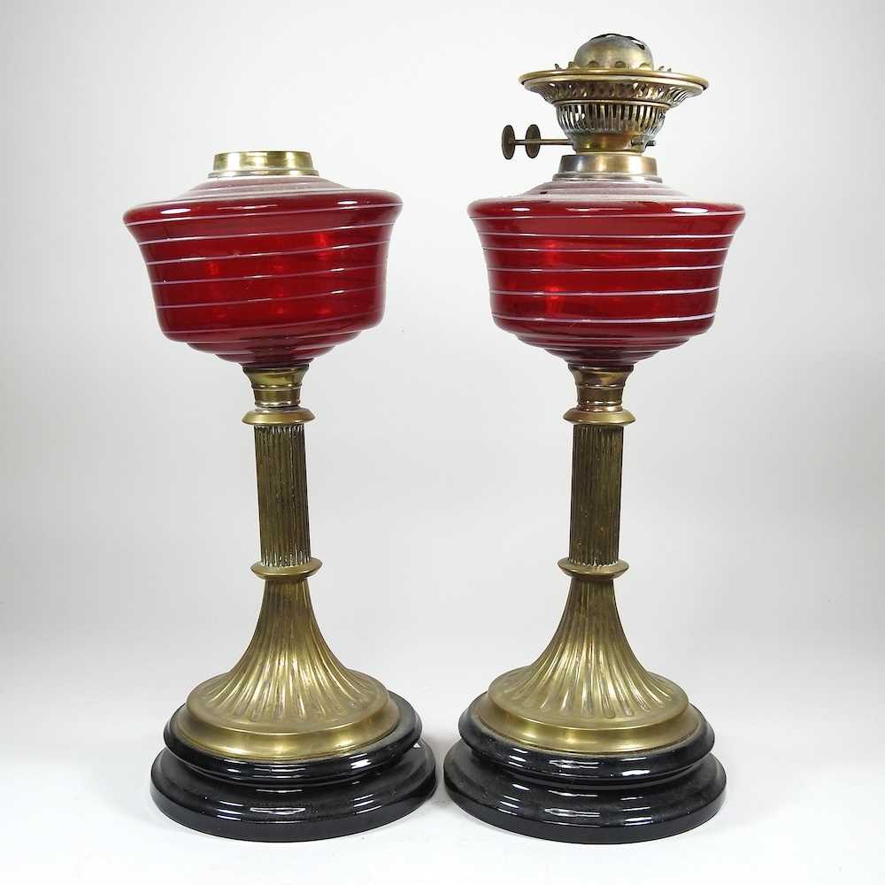 A pair of ruby striped glass oil lamps