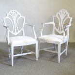 A pair of white painted armchairs