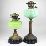 An oil lamp, with a green glass reservoir