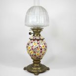 A painted and brass oil lamp