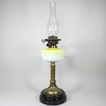 A brass and yellow glass oil lamp base