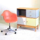 A red swivel chair and sideboard
