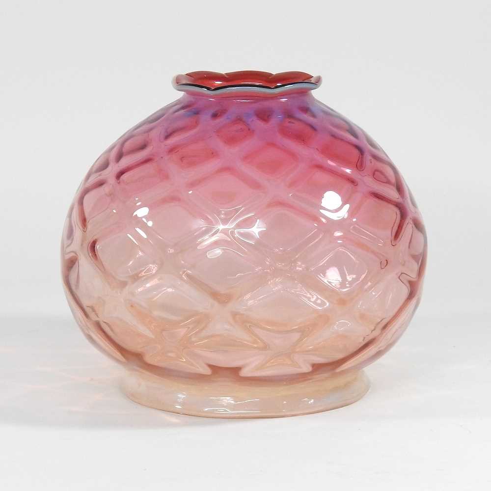 A pink glass oil lamp shade