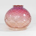 A pink glass oil lamp shade