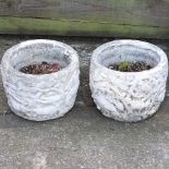 A pair of cast stone planters