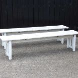 A pair of white painted folding slatted benches