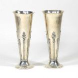 A pair of silver vases