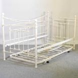 A cream painted metal day bed