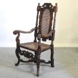 A carved oak open armchair