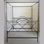 A black painted metal four poster bedstead
