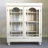 A white painted glazed bookcase