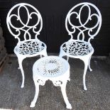 A pair of white painted metal chairs