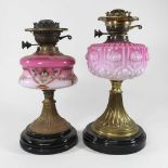 Two brass and pink oil lamp bases