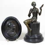 A bronze lady and a medallion