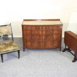 A walnut chest together with a table and a chair