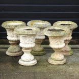 Five cast stone urns
