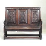 A carved oak settle