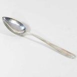 A silver basting spoon