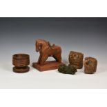 An assortment of small Indian carvings to include a naively carved horse, raised on rectangular