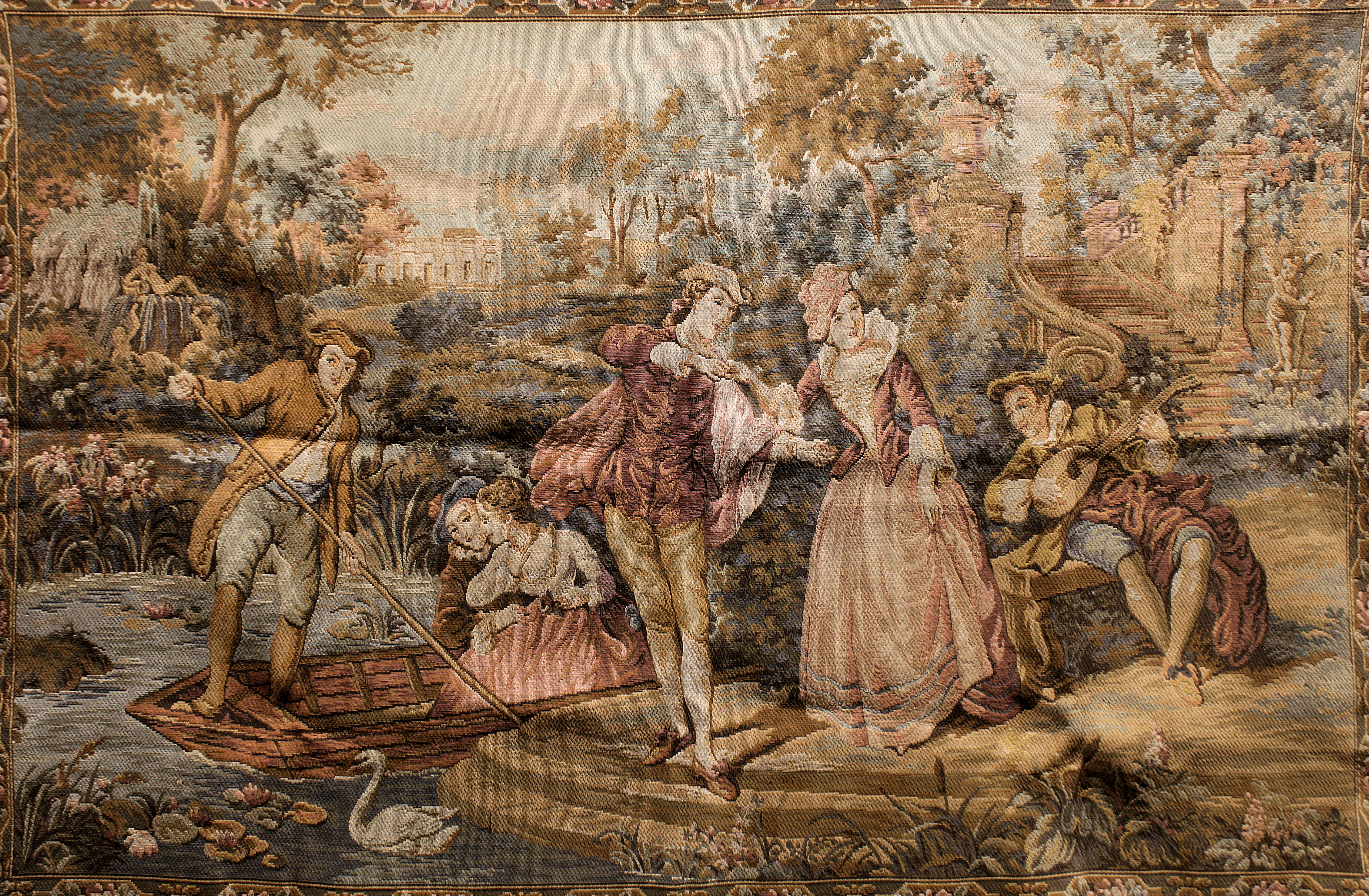 A French machine-made tapestry in the 18th century style depicting amorous couples and musicians