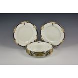 A set of eight 19th century armorial dinner plates with cobalt blue and gilt scroll and foliate