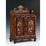 A Chinese hardwood and bone inlay table cabinet, c.1900, panelled top with shaped apron above a pair