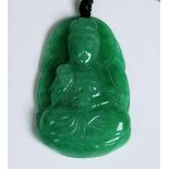 A modern green jade pendant with seated Buddha on cord with two beads, together with a cross pendant