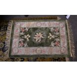 A small Chinese silk rug late 20th century, the central sage green field with floral decoration,