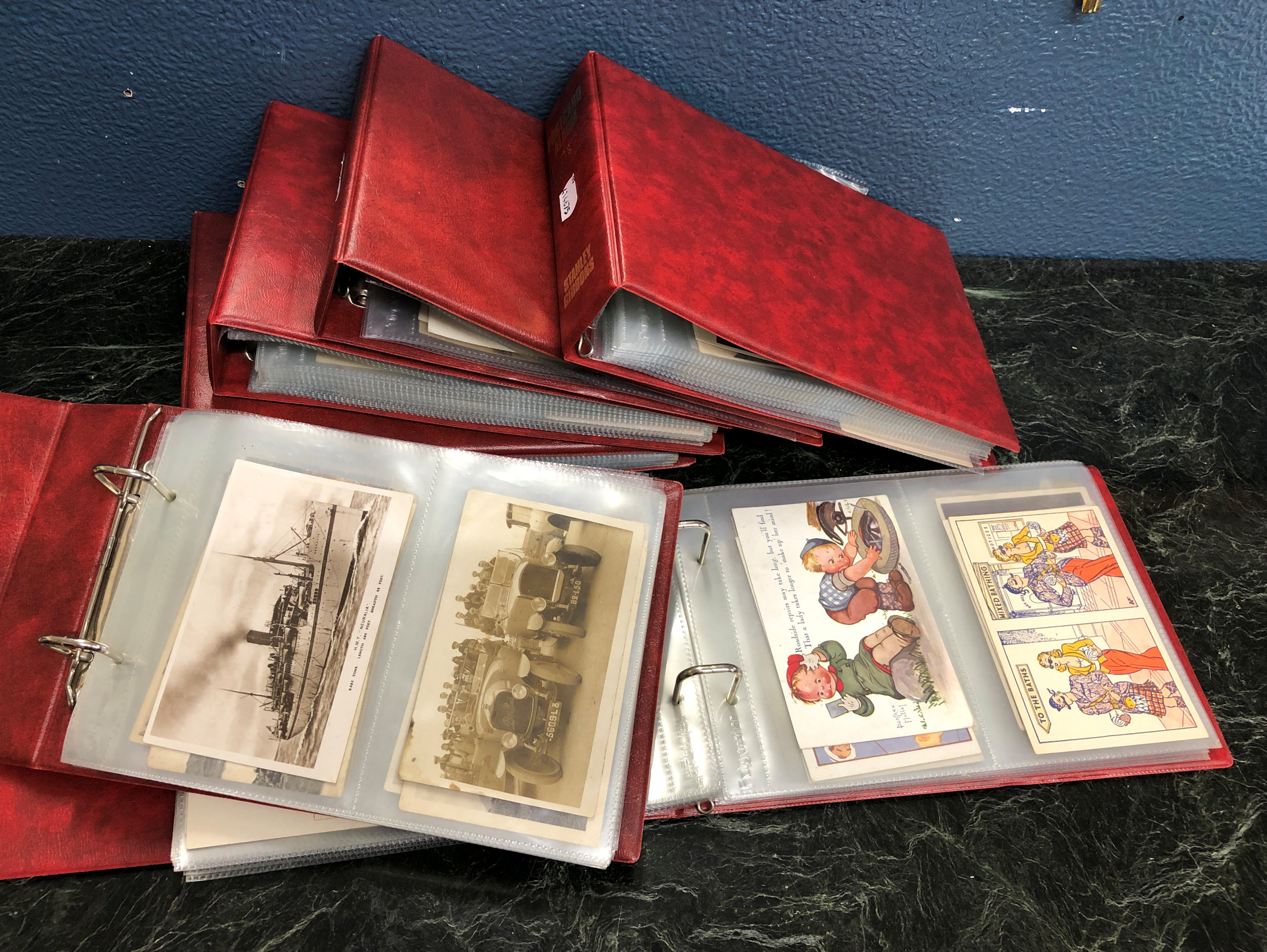 A collection of various vintage Worldwide postcards contained in six binders. (6) very large