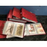A collection of various vintage Worldwide postcards contained in six binders. (6) very large