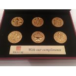 A cased corporate gift set of six gold plated Dilmun Seals.