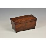A Regency mahogany sarcophagus form tea caddy the hinged cover, opening to reveal twin lidded