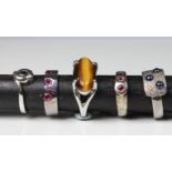 A collection of five silver rings set with various gemstones