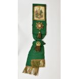 An Ancient Order of Forresters Jersey sash in green, with applied jewels and crest with gold