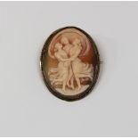 A metal mounted oval cameo brooch depicting the Three Graces.