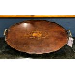 An Edwardian plum pudding mahogany and marquetry oval tray, with marquetry musical trophy, scalloped