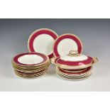 A 19th century Copeland part dinner service painted in deep pink with decorative gilt borders,