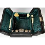 A fine Victorian travelling vanity or gentleman's toilet case the canvas slip protecting the black